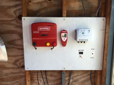 From the top left clockwise: Fencer, handheld fence tester, solar panel charge controller, windmill stop switch, battery voltmeter.